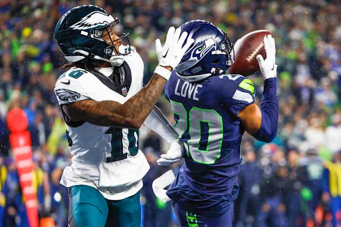 Seattle Seahawks safety Julian Love (20) intercepts a pass intended for Philadelphia Eagles wide receiver Quez Watkins (16) during the fourth quarter at Lumen Field.